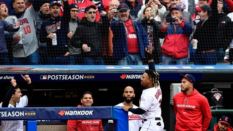 Cleveland Guardians' Jose Ramirez, center, waves to the fans from...
