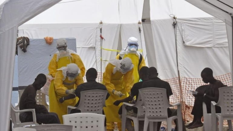 Health workers attend to patients that contracted the Ebola virus...