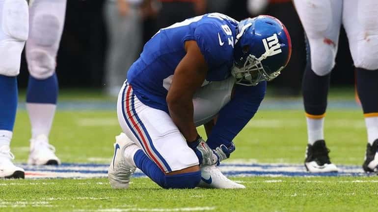 Sterling Shepard of the Giants reacts after being injured against...