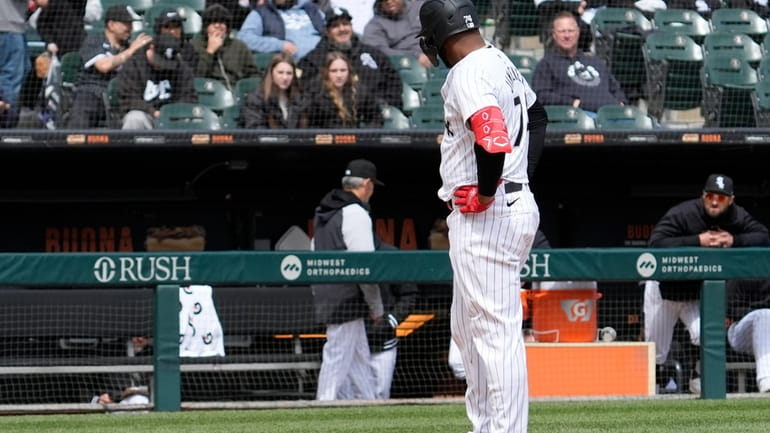 Chicago White Sox's Eloy Jimenez looks to the bench after...