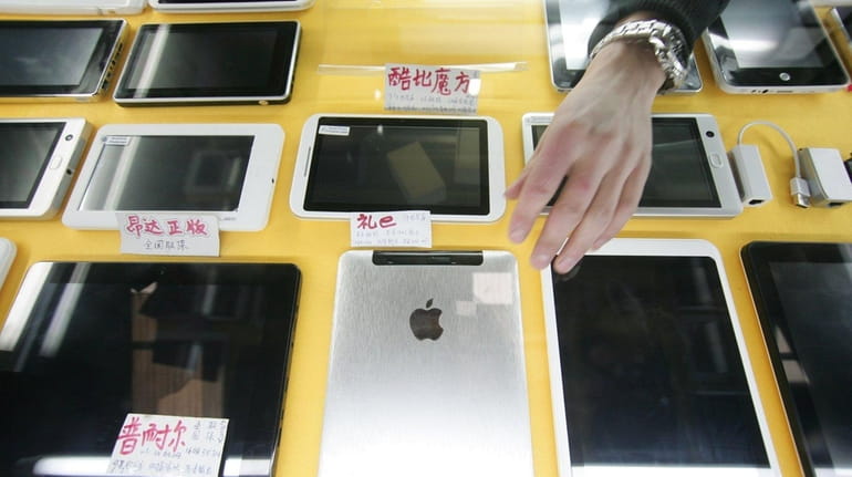 Some iPad-like devices are displayed at a shop in Shanghai,...