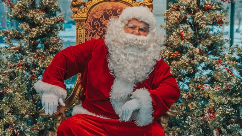 Santa greets those visiting the annual "Crystal City Christmas" festival,...