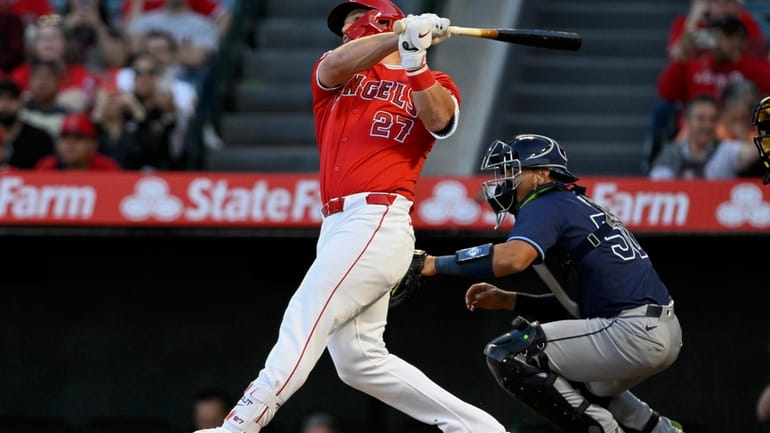 Los Angeles Angels' Mike Trout follows through on a two-run...