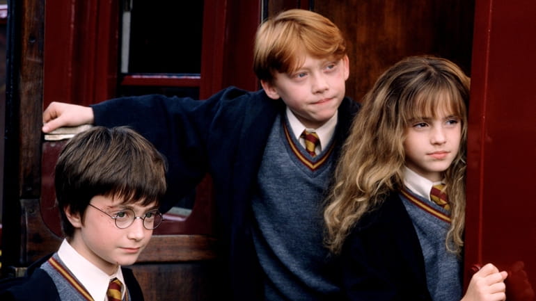 Daniel Radcliffe, Rupert Grint and Emma Watson star in "Harry...