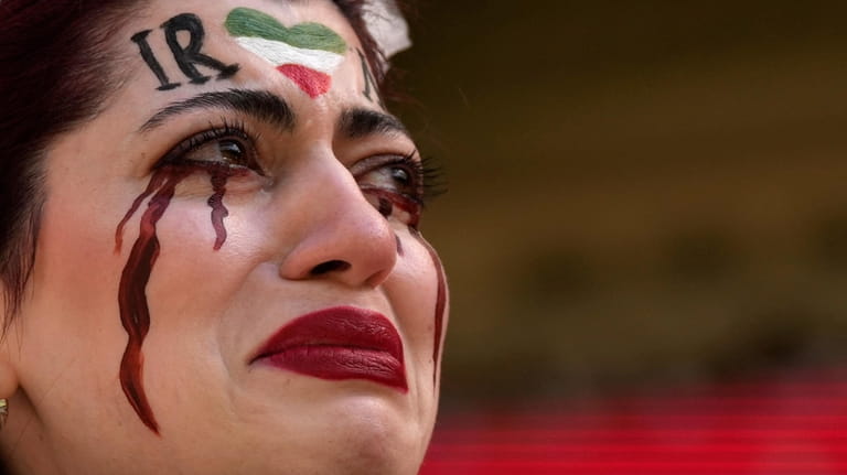 An Iranian woman, name not given, breaks into tears after...