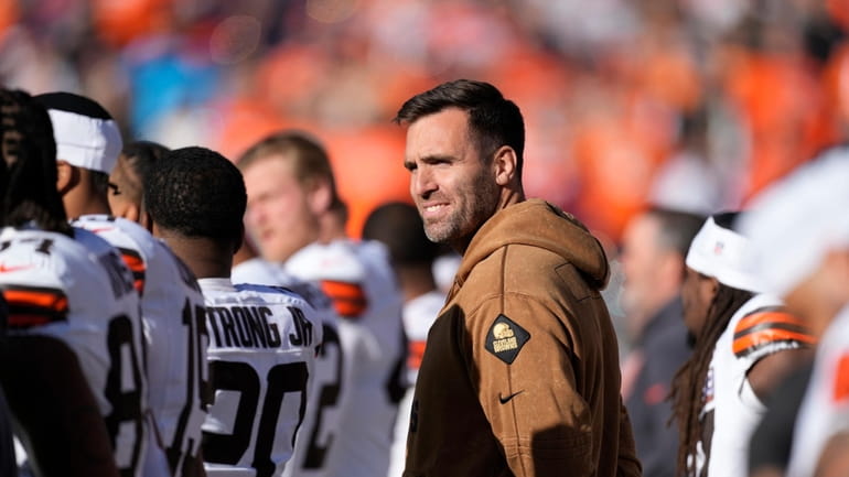 Cleveland Browns quarterback Joe Flacco stands with teammates during the...