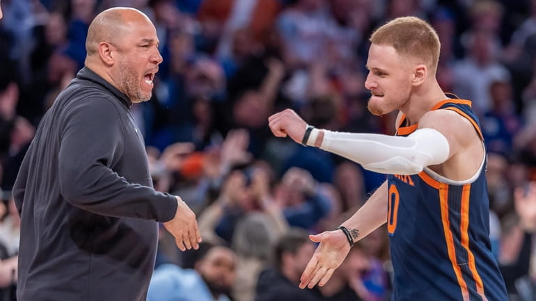 Knicks coach Rick Brunson celebrates with Donte DiVincenzo after DiVincenzo...
