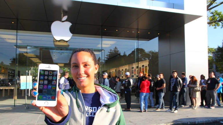 Chelsea Grippe shows off her new iPhone 5S outside the...