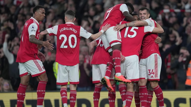 Arsenal players celebrate after Martin Odegaard scored his side's second...