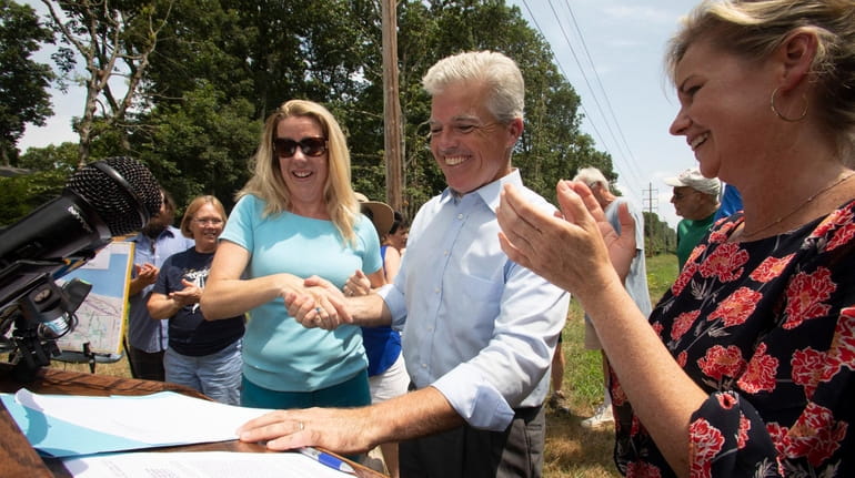 Suffolk County Executive Steve Bellone signs a bill to secure...