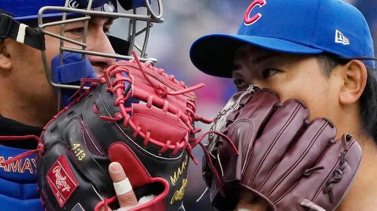 Chicago Cubs catcher Miguel Amaya, left, talks with starting pitcher...