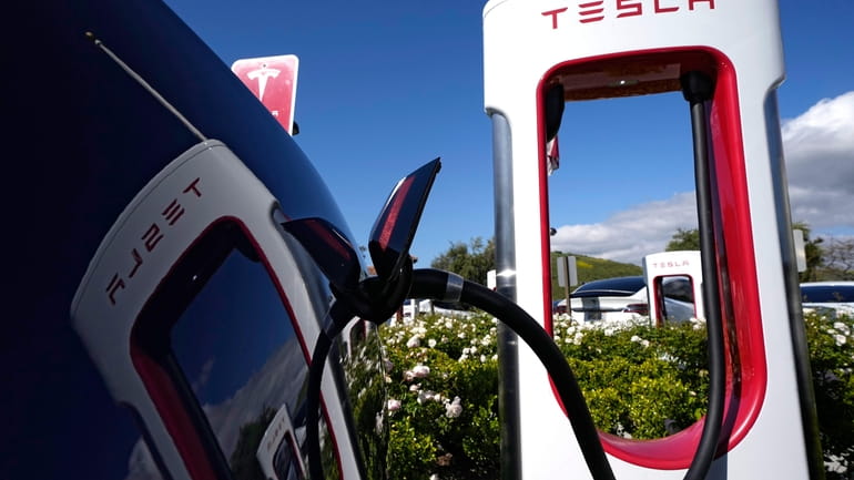 A Tesla auto charges on May 10, 2023, in Westlake,...