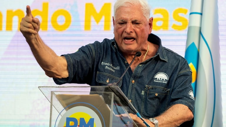 Panama's former President Ricardo Martinelli speaks to supporters during a...