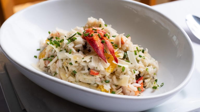 Lobster risotto with basil, chives, parmesan and orange served at...