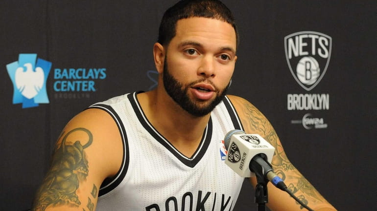 Nets point guard Deron Williams speaks to reporters during the...