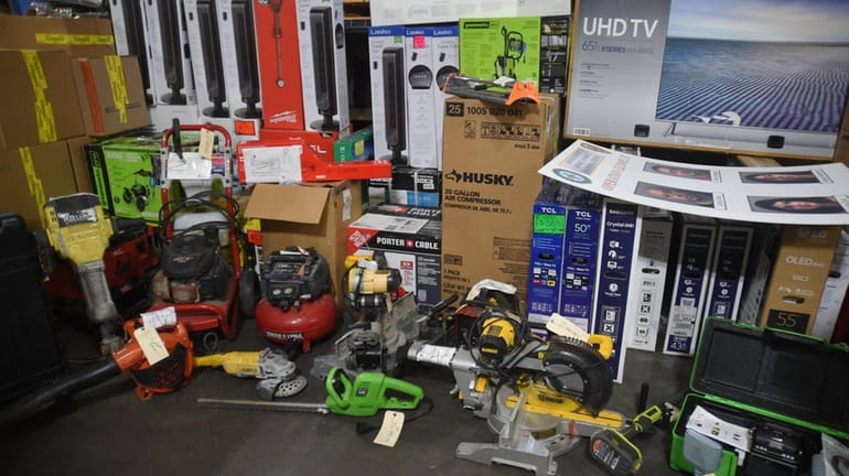 Suffolk County authorities display stolen merchandise seized in the takedown...