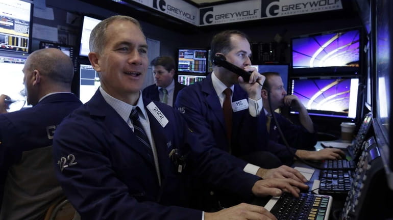 Trader Timothy Nick works with colleagues in a booth on...