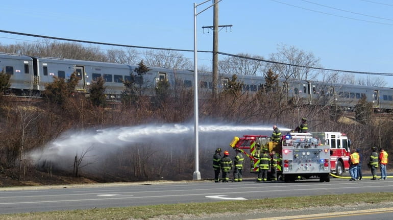 A brush fire along the Long Island Rail Road right...