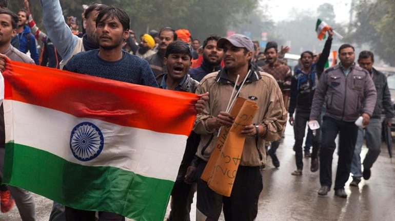 Indian protesters shout slogans against Thursday's attack on a paramilitary...
