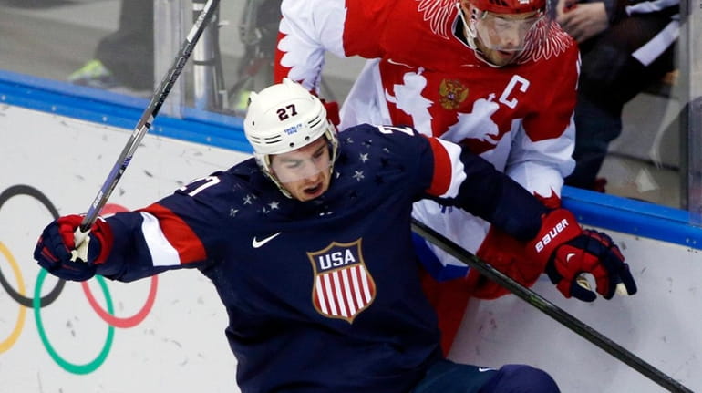 USA defenseman Ryan McDonagh collides with Russia forward Pavel Datsyuk...