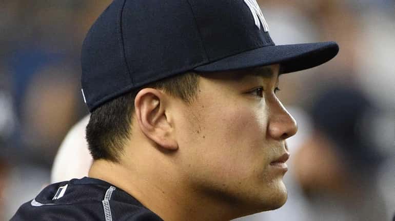 New York Yankees pitcher Masahiro Tanaka looks on from the...