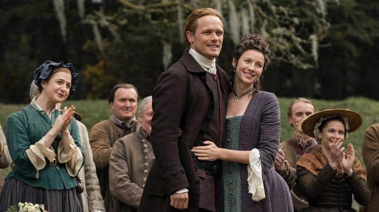 Sam Heughan as Jamie Fraser and Caitriona Balfe as Claire Fraser in...