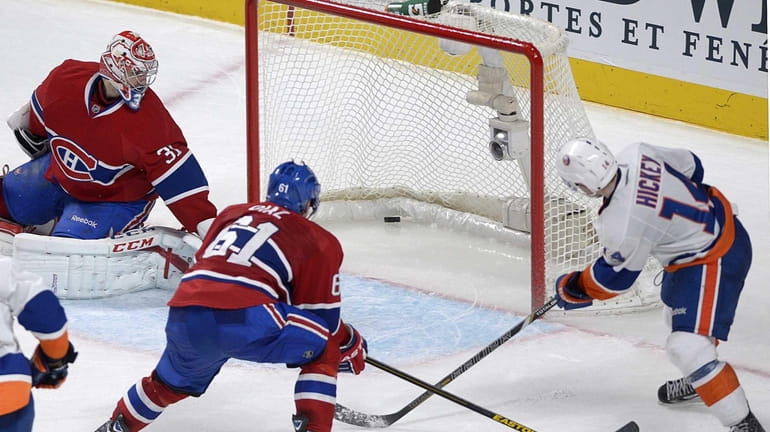 Islanders' Thomas Hickey scores the game winner against Canadians goaltender...