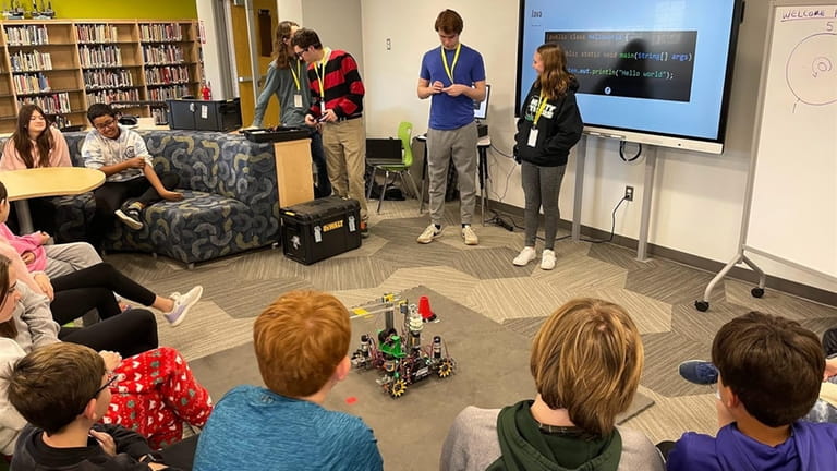In Greenlawn, members of Harborfields High School’s Robotics Club visit...