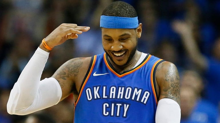 Thunder forward Carmelo Anthony gestures after hitting a three-point basket...