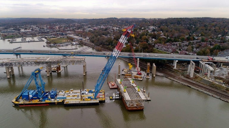 A section of the old Tappan Zee Bridge is lowered...