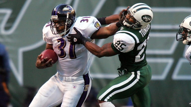 Ravens running back Jamal Lewis is run out of bounds...