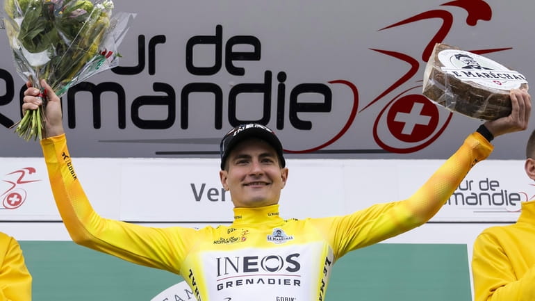 The winner of the Tour de Romandie, Carlos Rodriguez, right,...