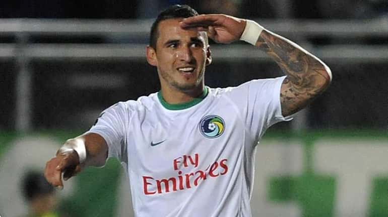 New York Cosmos forward Gaston Cellerino salutes the crowd after...
