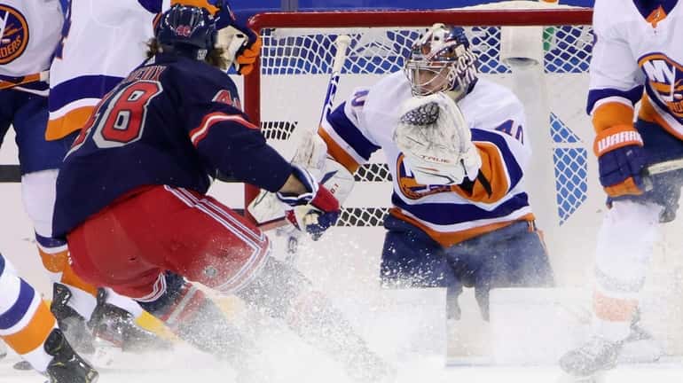 Islanders' Semyon Varlamov (40) blocks the net against Rangers' Brendan Lemieux...