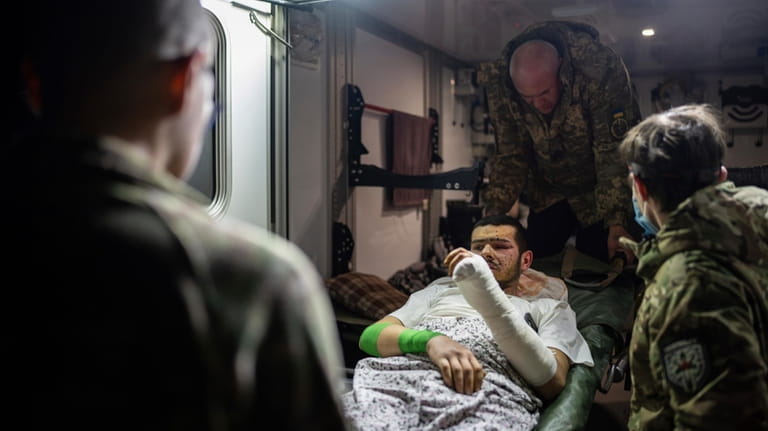 Medics of volunteer battalion "Hospitallers" move injured Ukrainian serviceman Mykola,...