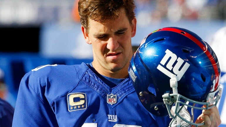 Eli Manning of the New York Giants looks on from...