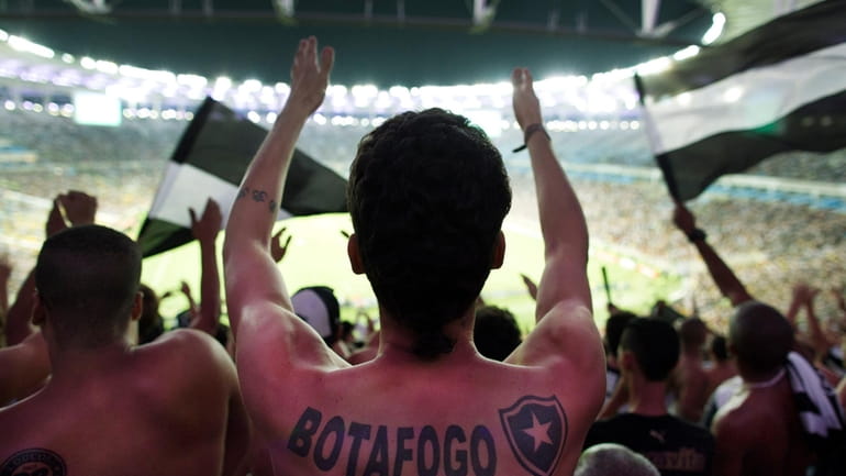Fans of the Botafogo soccer team react during a Copa...
