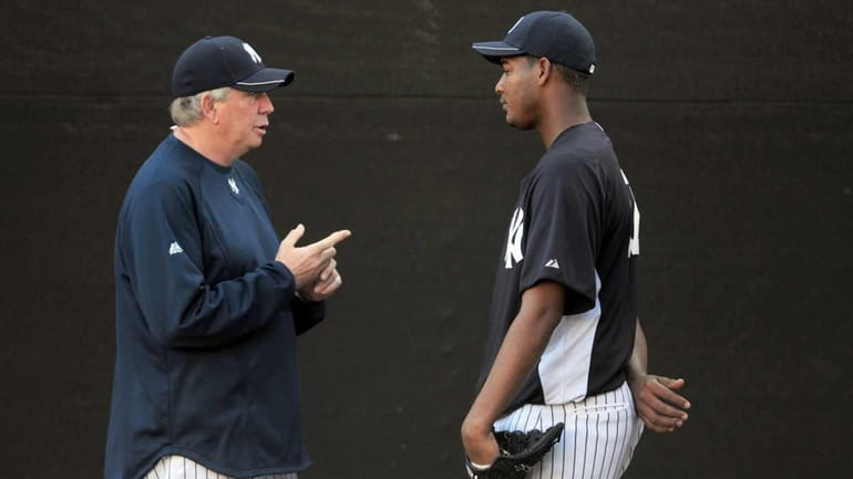 New York Yankees pitching coach LArry Rothschild speaks with pitcher...