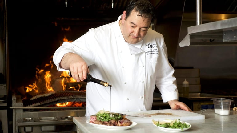 Executive chef Marco Pellegrini puts the finishing touch on a...