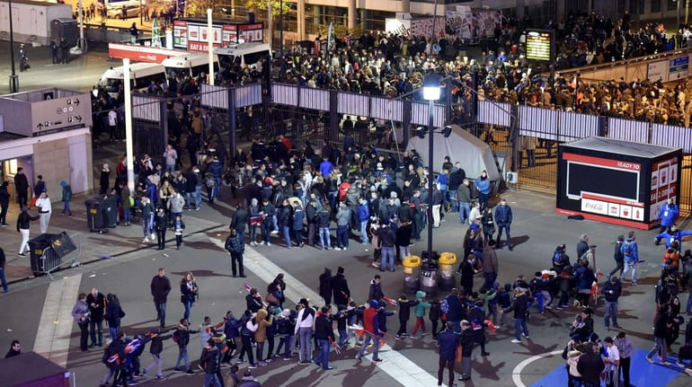 Soccer fans leave the Stade de France stadium in Saint-Denis,...