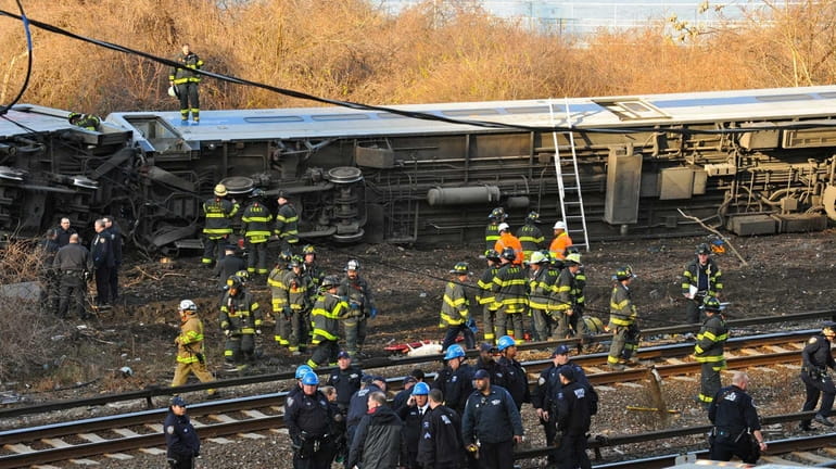 Emergency workers on the scene of the derailed Metro-North train...