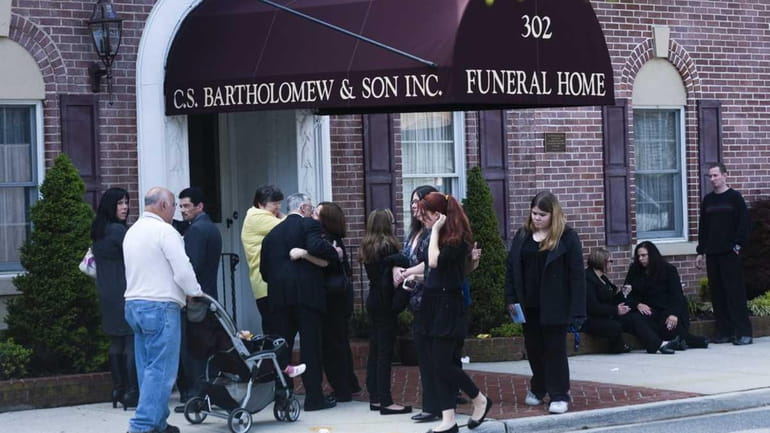 Mourners attend the wake and prayer service for murder victim...