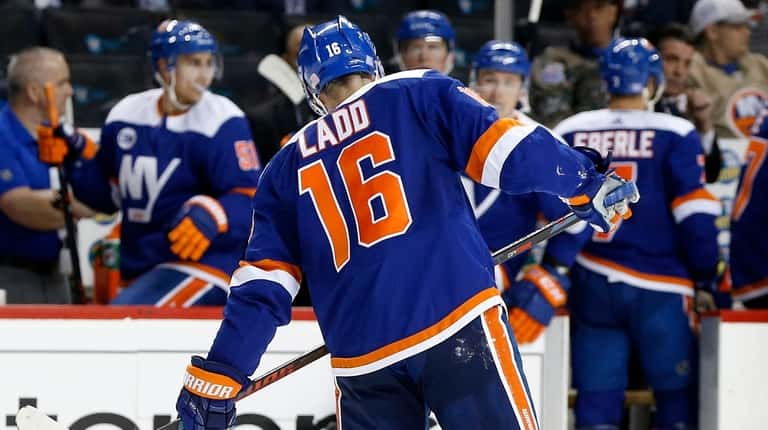Andrew Ladd  of the New York Islanders limps back to...