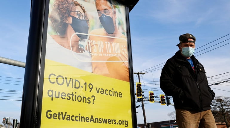 An advertisement for the COVID-19 vaccine is seen at a...