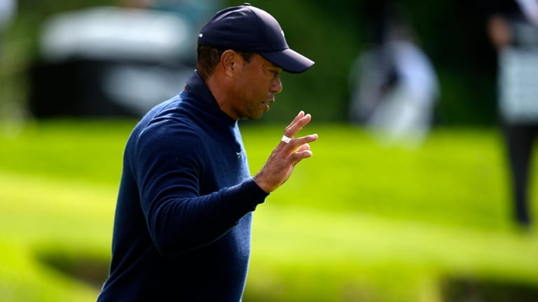 Tiger Woods acknowledges the gallery after finishing on the sixth...