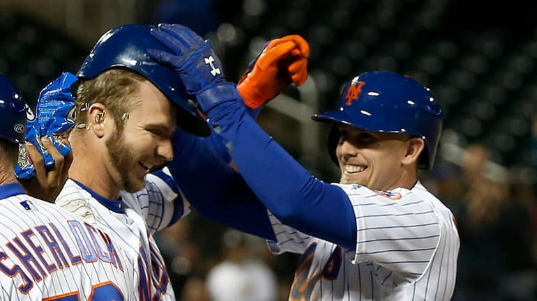 Pete Alonso #20 of the Mets celebrates his tenth inning game...