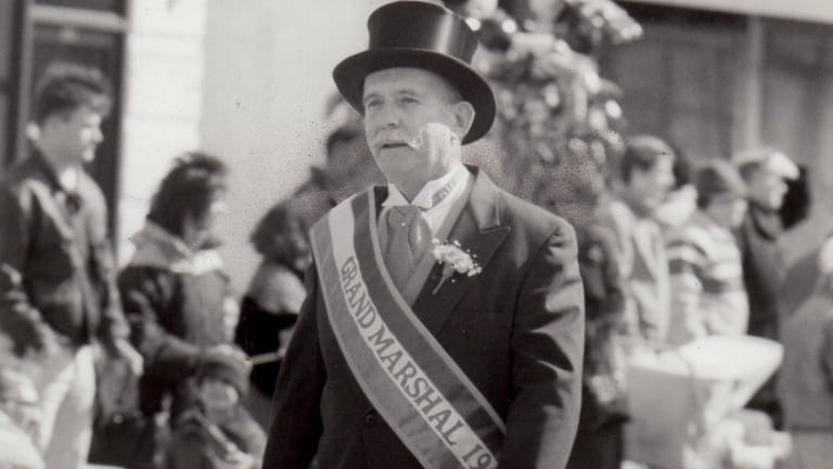 Grand Marshal William J. MacGuffin marches down Franklin Avenue in...