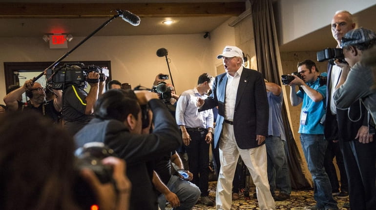 Republican Presidential candidate and business mogul Donald Trump talks to...