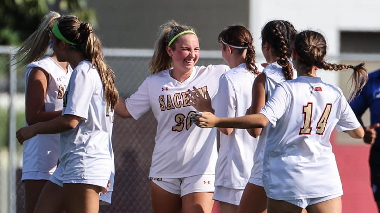 Sachem East teammates congratulate Kaitlin Conway after her opening goal...