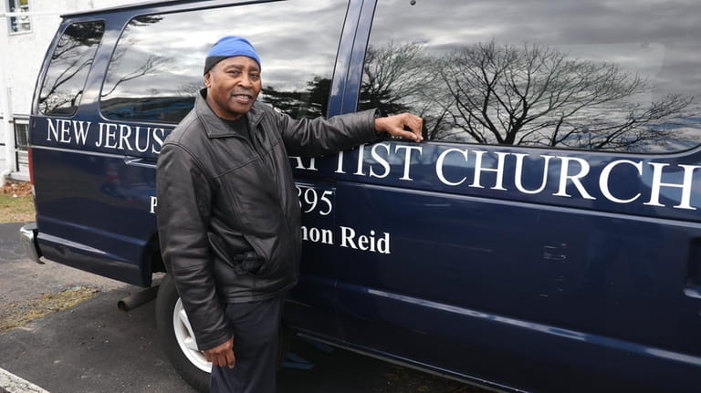 Marvin Smith next to a church van outside the New...